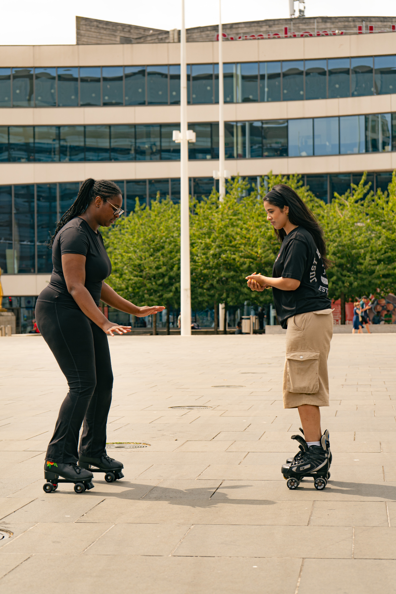 Coach guiding a skater in Birmingham's Centenary Square