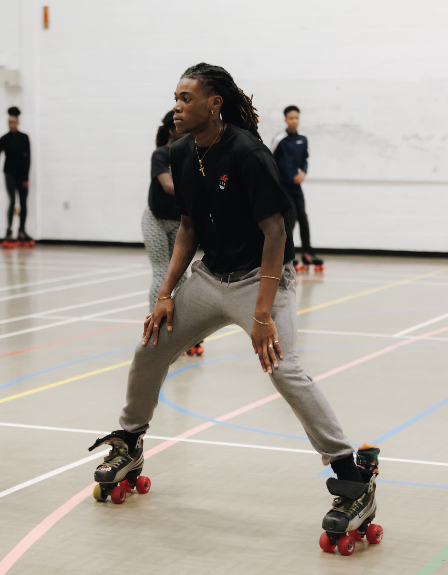 Beginner roller skating class in London with a coach on an indoor floor